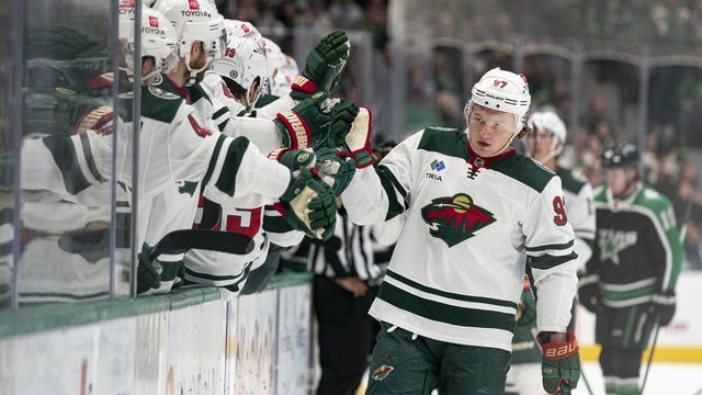 DALLAS, TEXAS - DECEMBER 04: Kirill Kaprizov #97 of the Minnesota Wild is congratulated by teammates after scoring a goal during the first period against the Dallas Stars at American Airlines Center on December 04, 2022 in Dallas, Texas.