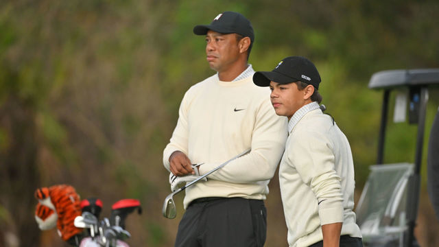 ORLANDO, FLORIDA - DECEMBER 16: Charlie Woods and his father, Tiger Woods, stand on the first fairway prior to the PGA TOUR Champions PNC Championship at The Ritz-Carlton Golf Club on December 16, 2022 in Orlando, Florida.