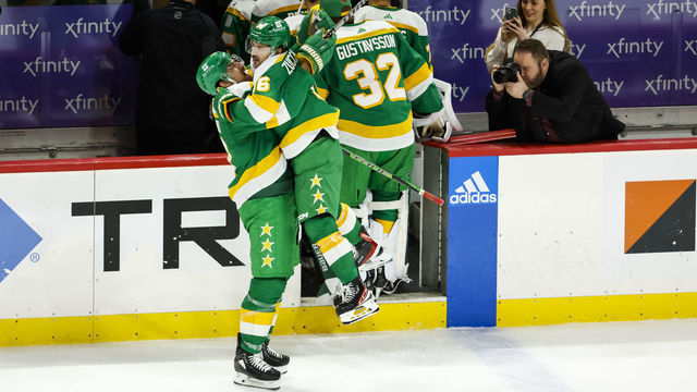 ST PAUL, MN - DECEMBER 16: Marcus Foligno #17 (L) and Mats Zuccarello #36 of the Minnesota Wild celebrate their victory against the Chicago Blackhawks after the game at Xcel Energy Center on December 16, 2022 in St Paul, Minnesota. The Wild defeated the Blackhawks 4-1.