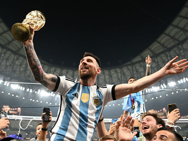 LUSAIL CITY, QATAR - DECEMBER 18: Lionel Messi of Argentina celebrates with the FIFA World Cup Qatar 2022 Winner's Trophy after the team's victory during the FIFA World Cup Qatar 2022 Final match between Argentina and France at Lusail Stadium on December 18, 2022 in Lusail City, Qatar.