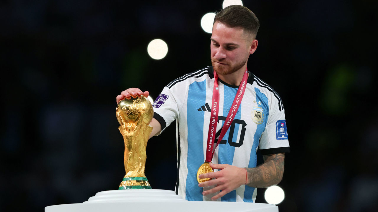 LUSAIL CITY, QATAR - DECEMBER 18: Alexis Mac Allister of Argentina kisses the World Cup trophy after the FIFA World Cup Qatar 2022 Final match between Argentina and France at Lusail Stadium on December 18, 2022 in Lusail City, Qatar.