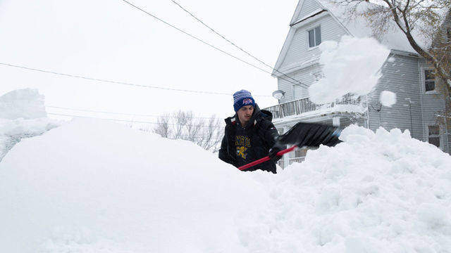 BUFFALO, NY - NOVEMBER 18: Thomas Gilmore works to free his buried car after a snowstorm in Buffalo, New York on Friday Nov. 18, 2022.
