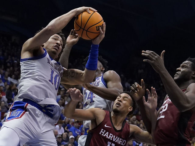 LAWRENCE, KANSAS - DECEMBER 22: Jalen Wilson #10 of the Kansas Jayhawks rebounds the ball against teammate K.J. Adams Jr. #24, Evan Nelson #11 and Justice Ajogbor #22 of the Harvard Crimson in the second half at Allen Fieldhouse on December 22, 2022 in Lawrence, Kansas.