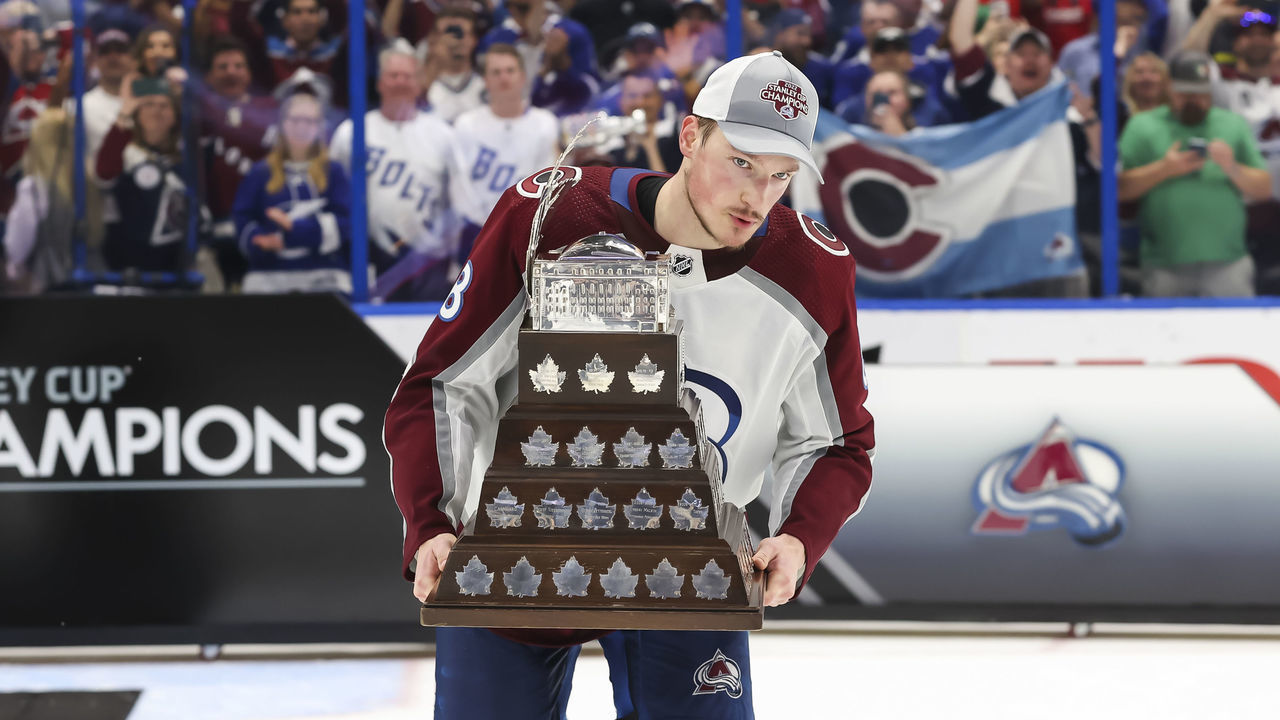 TAMPA, FL - JUNE 26: Cale Makar #8 of the Colorado Avalanche accepts the Conn Smythe trophy for Stanley Cup playoff MVP from NHL Deputy Commissioner Bill Daly after Game Six of the 2022 Stanley Cup Final at Amalie Arena on June 26, 2022 in Tampa, Florida. The Avalanche defeated the Lightning four games to two.