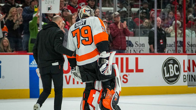 RALEIGH, NORTH CAROLINA - DECEMBER 23: Carter Hart #79 of the Philadelphia Flyers is helped off the ice after suffering an injury during the second period of a game against the Carolina Hurricanes at PNC Arena on December 23, 2022 in Raleigh, North Carolina.