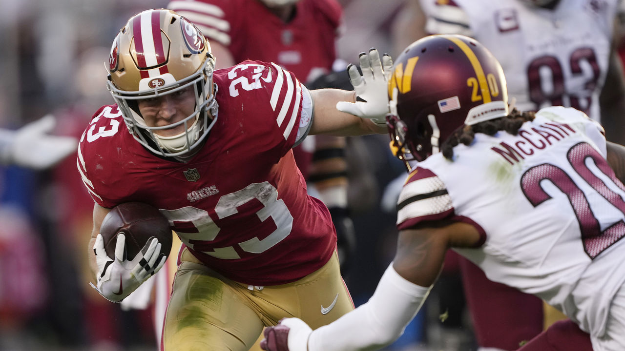SANTA CLARA, CALIFORNIA - DECEMBER 24: Christian McCaffrey #23 of the San Francisco 49ers stiff arms Bobby McCain #20 of the Washington Commanders during the fourth quarter at Levi's Stadium on December 24, 2022 in Santa Clara, California.