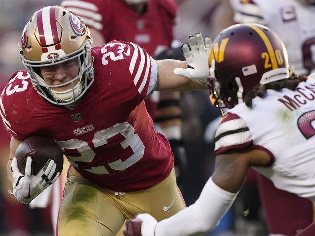 SANTA CLARA, CALIFORNIA - DECEMBER 24: Christian McCaffrey #23 of the San Francisco 49ers stiff arms Bobby McCain #20 of the Washington Commanders during the fourth quarter at Levi's Stadium on December 24, 2022 in Santa Clara, California.