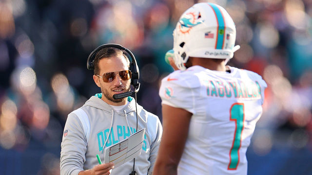 CHICAGO, ILLINOIS - NOVEMBER 06: Head coach Mike McDaniel of the Miami Dolphins talks with Tua Tagovailoa #1 during the fourth quarter in the game against the Chicago Bears at Soldier Field on November 06, 2022 in Chicago, Illinois.