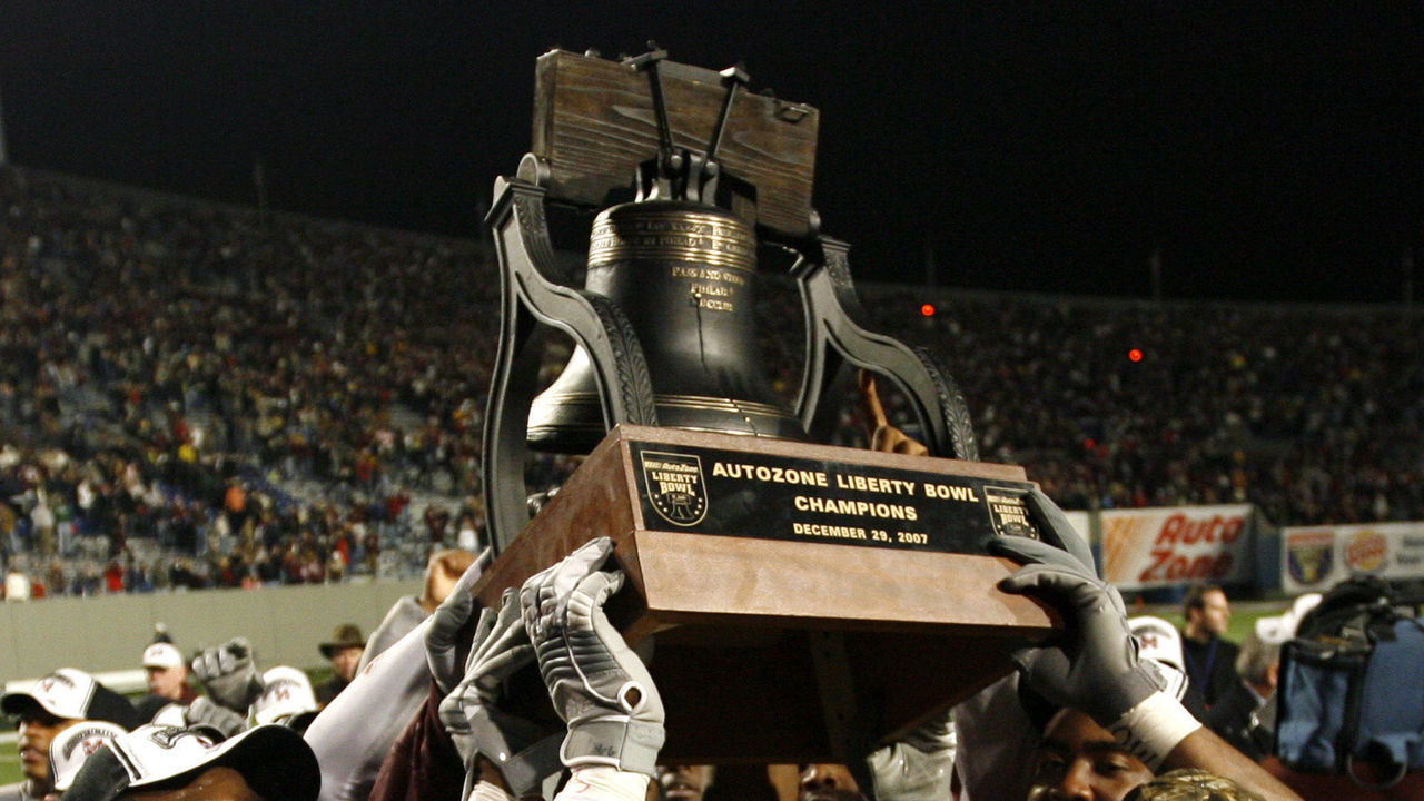 MEMPHIS, TN - DECEMBER 29: Jamon Hughes #36 of the Mississippi State Bulldogs holds up the Liberty Bowl trophy after their victory over the UCF Knights during the 49th Annual Autozone Liberty Bowl at Liberty Bowl Memorial Stadium December 29, 2007 in Memphis, Tennessee. The Bulldogs beat the Knights 10-3.