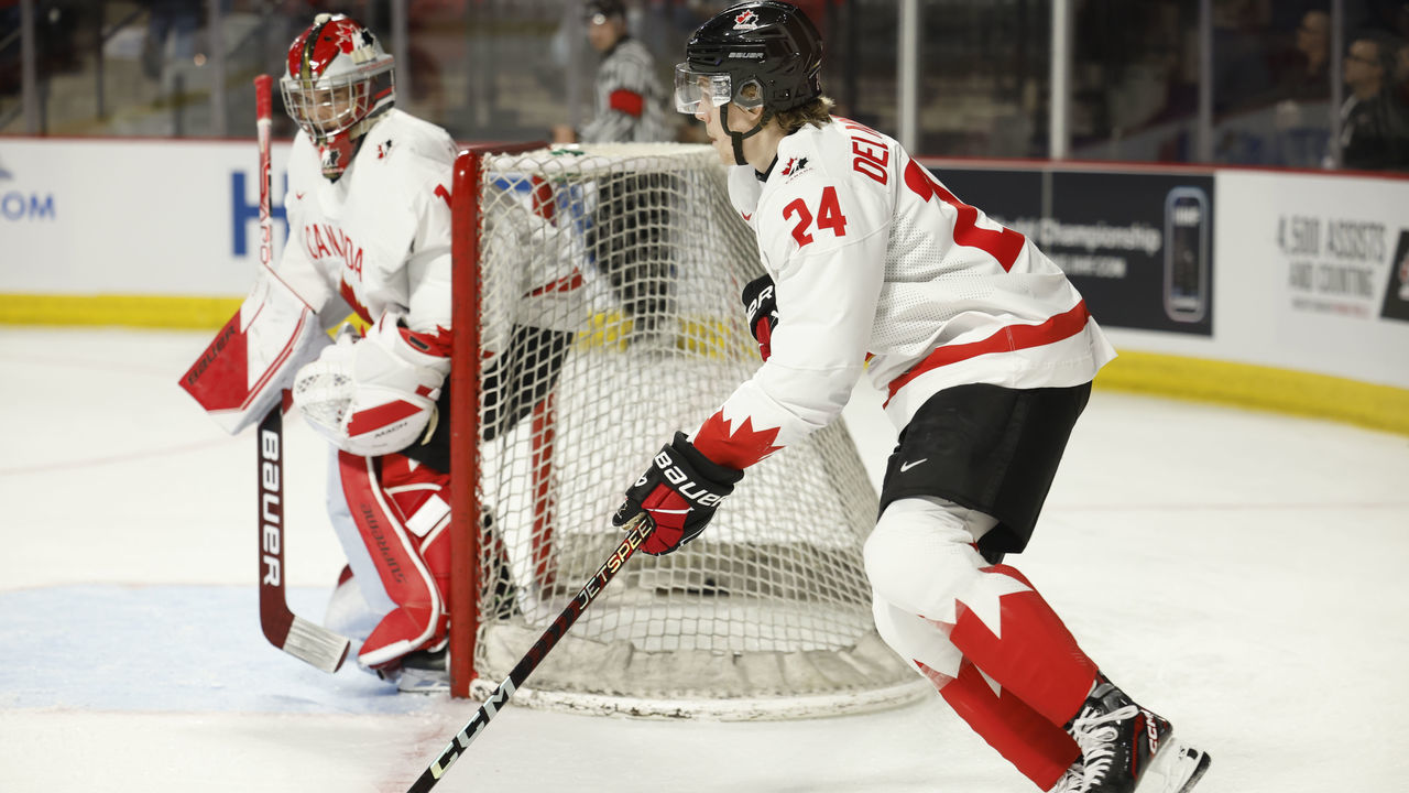 MONCTON, NB - DECEMBER 19: Ethan Delmastro #24 of team Canada skates puck from behind net against Team Switzerland in the first period during the 2023 IIHF World Junior Championship game at Avenir Centre on December 19, 2022 in Moncton, Canada.