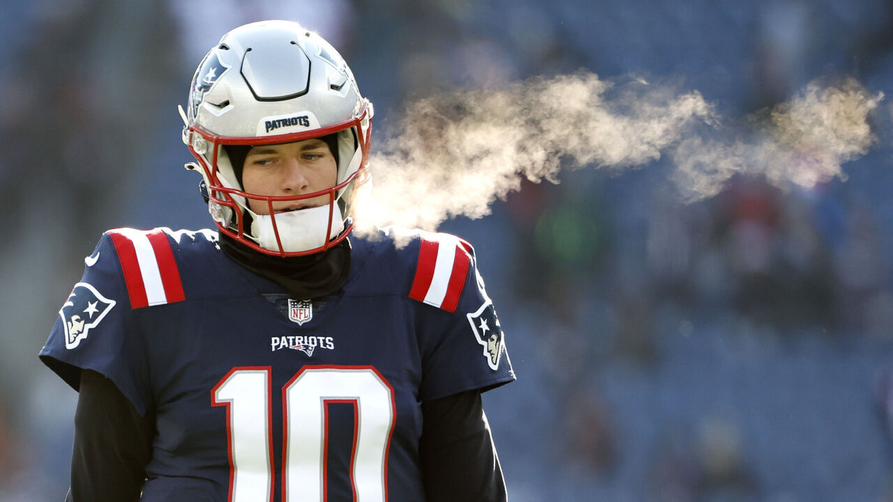 FOXBOROUGH, MASSACHUSETTS - DECEMBER 24: Mac Jones #10 of the New England Patriots looks on during pregame against the Cincinnati Bengals at Gillette Stadium on December 24, 2022 in Foxborough, Massachusetts.