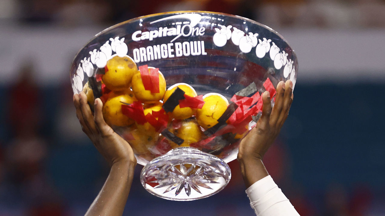 MIAMI GARDENS, FLORIDA - DECEMBER 31: Derion Kendrick #11 of the Georgia Bulldogs raises the trophy after defeating the Michigan Wolverines 34-11 in the Capital One Orange Bowl for the College Football Playoff semifinal game at Hard Rock Stadium on December 31, 2021 in Miami Gardens, Florida.