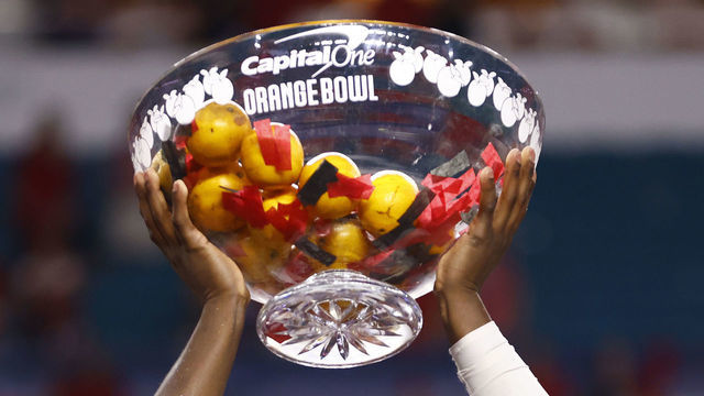 MIAMI GARDENS, FLORIDA - DECEMBER 31: Derion Kendrick #11 of the Georgia Bulldogs raises the trophy after defeating the Michigan Wolverines 34-11 in the Capital One Orange Bowl for the College Football Playoff semifinal game at Hard Rock Stadium on December 31, 2021 in Miami Gardens, Florida.