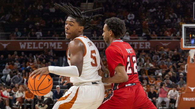 AUSTIN, TX - DECEMBER 21: Texas Longhorns guard Marcus Carr (5) spins away from Louisiana Lafayette Ragin Cajuns guard Kentrell Garnett (22) during the game between Texas Longhorns and Louisiana Lafayette Ragin Cajuns on December 21, 2022, at Moody Center in Austin, TX.