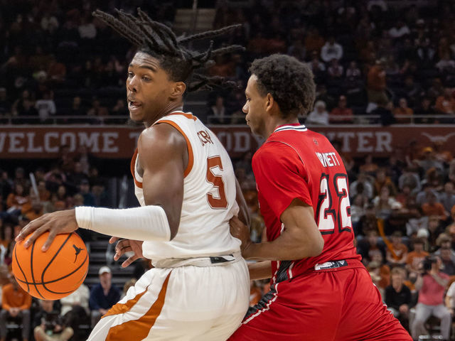 AUSTIN, TX - DECEMBER 21: Texas Longhorns guard Marcus Carr (5) spins away from Louisiana Lafayette Ragin Cajuns guard Kentrell Garnett (22) during the game between Texas Longhorns and Louisiana Lafayette Ragin Cajuns on December 21, 2022, at Moody Center in Austin, TX.