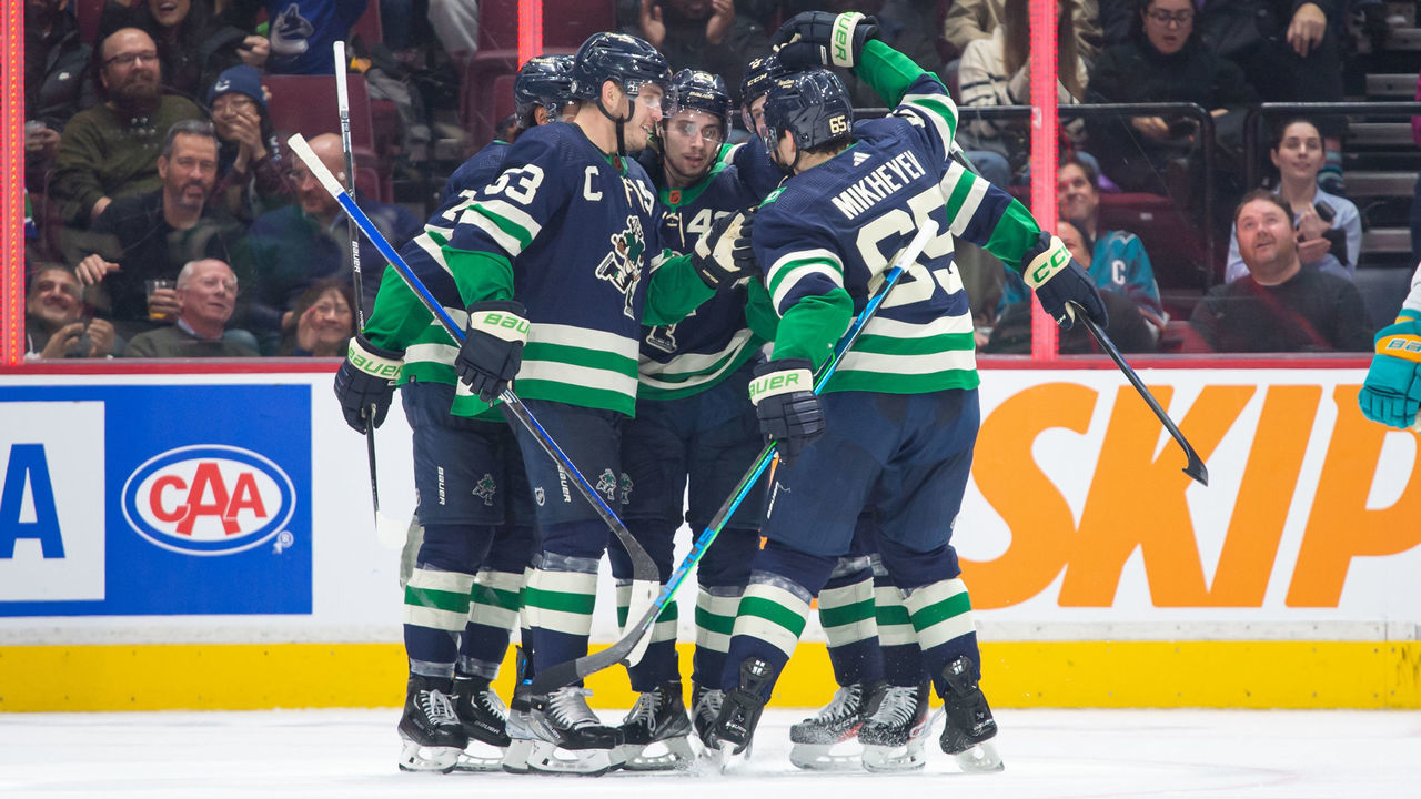 VANCOUVER, CANADA - DECEMBER 27: Quinn Hughes #43 of the Vancouver Canucks is congratulated after scoring a goal against the San Jose Sharks during the second period of their NHL game at Rogers Arena on December 27, 2022 in Vancouver, British Columbia, Canada.