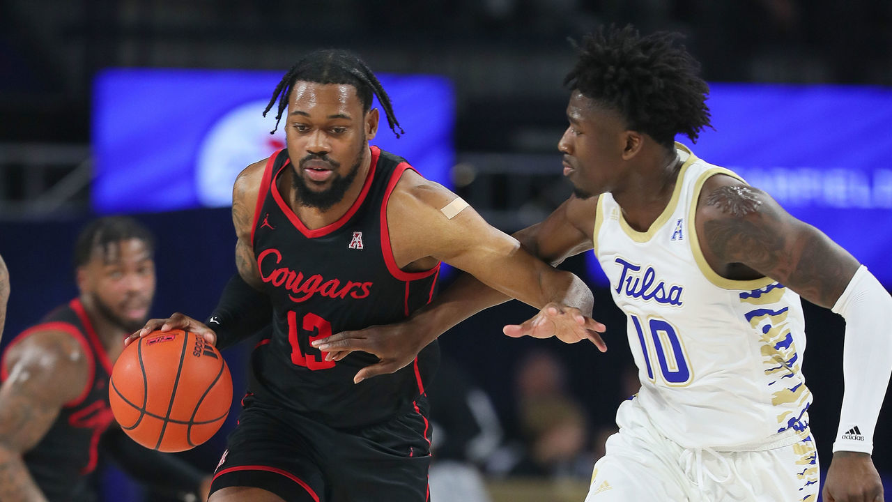 TULSA, OK - DECEMBER 28: Houston Cougars Forward J'Wan Roberts (13) dribbles as Tulsa Golden Hurricane Forward Tim Dalger (10) defends during a game between the Tulsa Golden Hurricane and the Houston Cougars on December 28, 2022, at the Reynolds Center in Tulsa, Oklahoma.