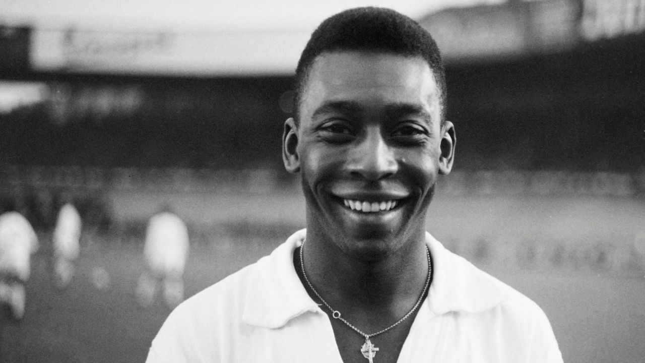Brazilian striker Pelé, wearing his Santos jersey, smiles before playing a friendly soccer match with his club against the French club of "Racing", on June 13, 1961 in Colombes, in the suburbs of Paris. - Pelé score one goal as Santos won 5-4. Widely considered to be the greatest player in soccer history, Pelé scored 1282 goals in his career and won three World Cup titles with Brazil (1958 in Sweden, 1962 in Chile, 1970 in Mexico).