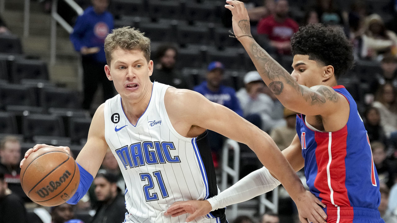 DETROIT, MICHIGAN - DECEMBER 28: Moritz Wagner #21 of the Orlando Magic handles the ball against Killian Hayes #7 of the Detroit Pistons during the first quarter at Little Caesars Arena on December 28, 2022 in Detroit, Michigan.