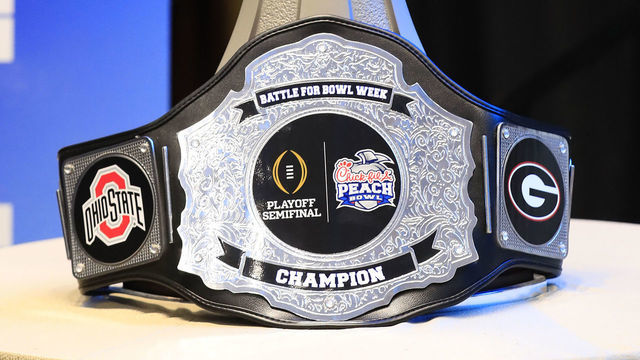 ATLANTA, GA - DECEMBER 26: The Peach Bowl Trophy and the Battle for the Bowl Champions belt during the Battle for Bowl Week dinner between the University of Georgia Bulldogs and The Ohio State Buckeyes at the College Football Hall of Fame on December 26, 2022 in Atlanta, GA.