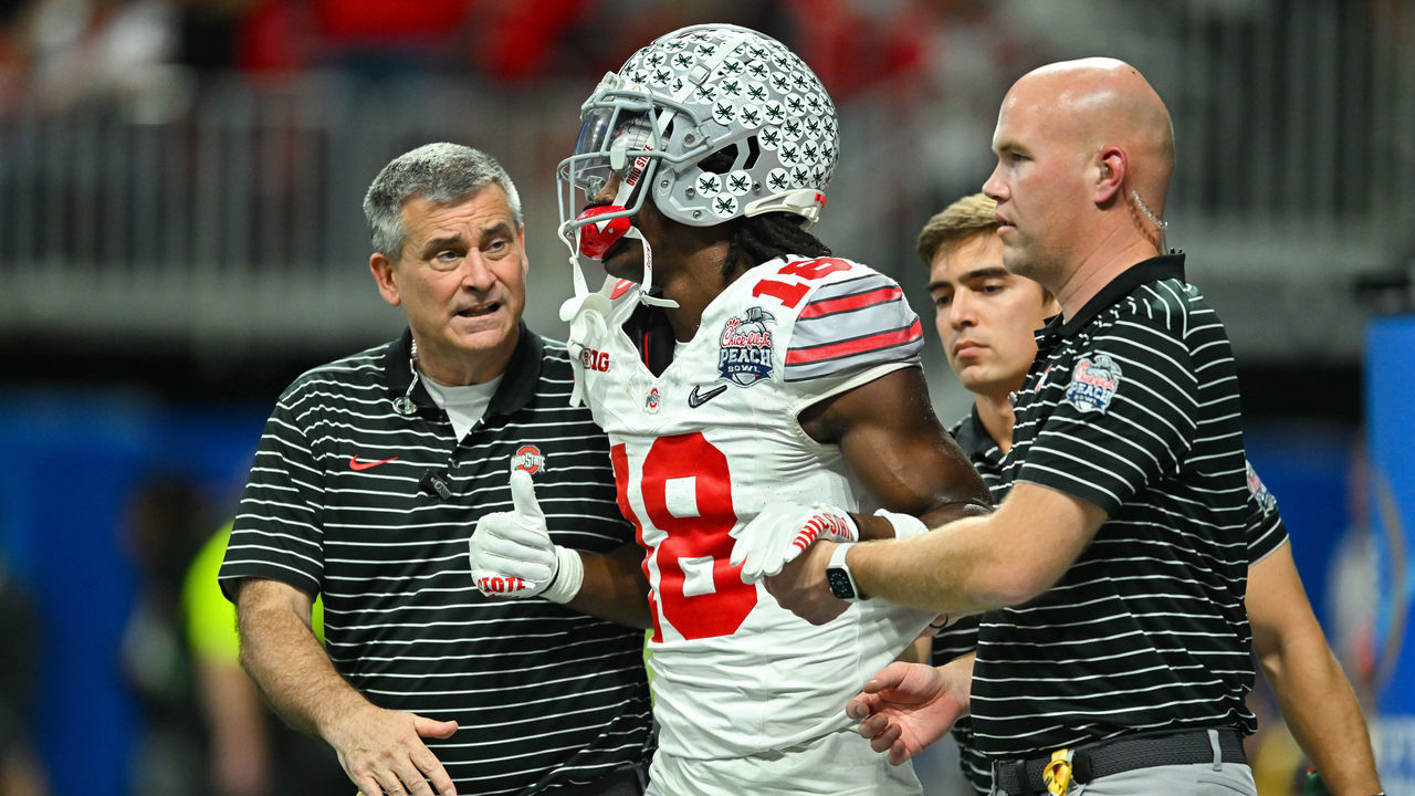 ATLANTA, GA DECEMBER 31: Ohio State wide receiver Marvin Harrison Jr. (18) is checked on by medical personnel during the Chick-fil-A Peach Bowl semifinal college football playoff between the Ohio State Buckeyes and the Georgia Bulldogs on December 31st, 2022 at Mercedes-Benz Stadium in Atlanta, GA.