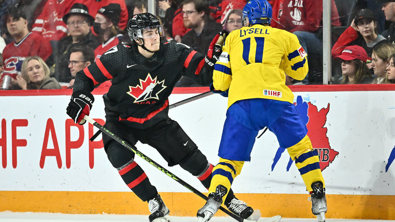 HALIFAX, CANADA - DECEMBER 31: Colton Dach #17 of Team Canada pushes back Fabian Lysell #11 of Team Sweden during the second period in the 2023 IIHF World Junior Championship at Scotiabank Centre on December 31, 2022 in Halifax, Nova Scotia, Canada.