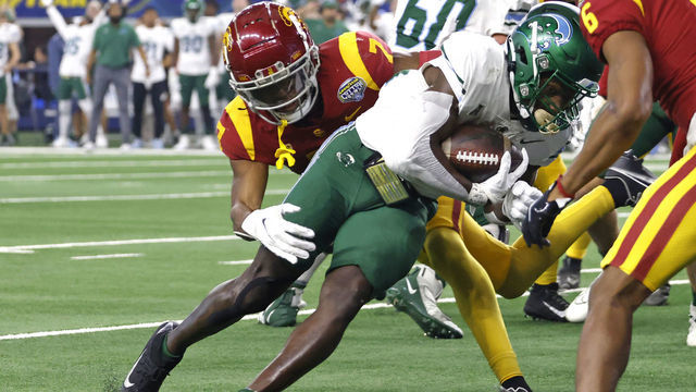 ARLINGTON, TX - JANUARY 2: Tyjae Spears #22 of the Tulane Green Wave runs the ball in for a touchdown as Calen Bullock #7 of the USC Trojans tries to make the stop in the first half of the Goodyear Cotton Bowl Classic on January 2, 2023 at AT&T Stadium in Arlington, Texas.
