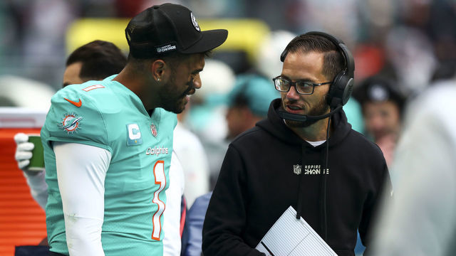 MIAMI GARDENS, FL - DECEMBER 25: Tua Tagovailoa #1 of the Miami Dolphins talks with head coach Mike McDaniel on the sidelines during the first quarter of an NFL football game against the Green Bay Packers at Hard Rock Stadium on December 25, 2022 in Miami Gardens, Florida.