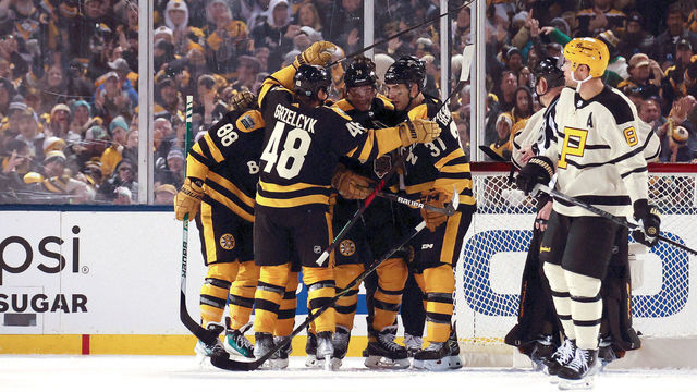 BOSTON, MASSACHUSETTS - JANUARY 02: Jake DeBrusk #74 of the Boston Bruins celebrates with teammates after scoring a goal against the Pittsburgh Penguins during the third period in the 2023 Discover NHL Winter Classic at Fenway Park on January 02, 2023 in Boston, Massachusetts.
