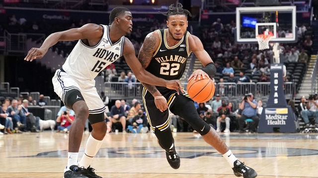 WASHINGTON, DC - JANUARY 04: Cam Whitmore #22 of the Villanova Wildcats dribbles by Bryson Mozone #15 of the Georgetown Hoyas in the second half half during a basketball game at the Capital One Arena on January 04, 2023 in Washington, DC.