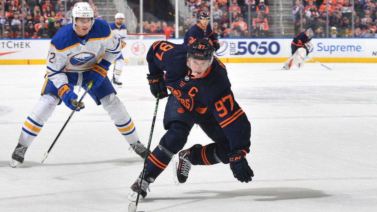 EDMONTON, CANADA - OCTOBER 18: Connor McDavid #97 of the Edmonton Oilers skates with the puck while being pursued by Tage Thompson #72 of the Buffalo Sabres on October 18, 2022 at Rogers Place in Edmonton, Alberta, Canada.