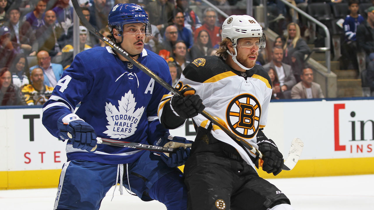 TORONTO, ON - OCTOBER 19: David Pastrnak #88 of the Boston Bruins skates against Auston Matthews #34 of the Toronto Maple Leafs during an NHL game at Scotiabank Arena on October 19, 2019 in Toronto, Ontario, Canada.