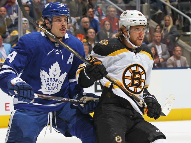 TORONTO, ON - OCTOBER 19: David Pastrnak #88 of the Boston Bruins skates against Auston Matthews #34 of the Toronto Maple Leafs during an NHL game at Scotiabank Arena on October 19, 2019 in Toronto, Ontario, Canada.