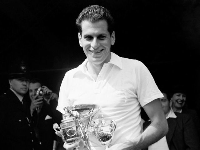 Men's singles champion Dick Savitt with the trophy after his straight sets win