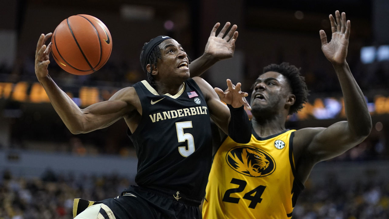 COLUMBIA, MISSOURI - JANUARY 07: Ezra Manjon #5 of the Vanderbilt Commodores lays the ball up against Kobe Brown #24 of the Missouri Tigers in the second half at Mizzou Arena on January 07, 2023 in Columbia, Missouri.