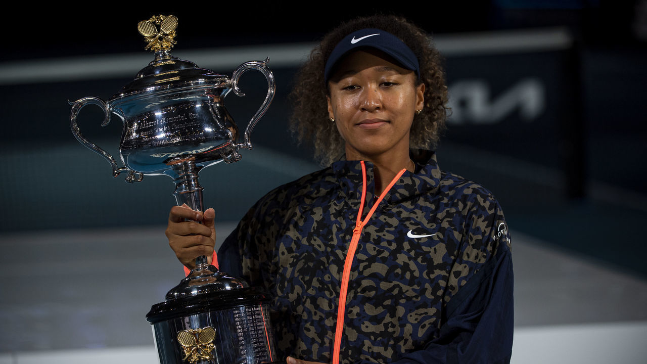 MELBOURNE, AUSTRALIA - FEBRUARY 20: Naomi Osaka of Japan celebrates with the Trophy after defeating Jennifer Brady of the United States in the women's singles final, during day 13 of the 2021 Australian Open at Melbourne Park on February 20, 2021 in Melbourne, Australia.