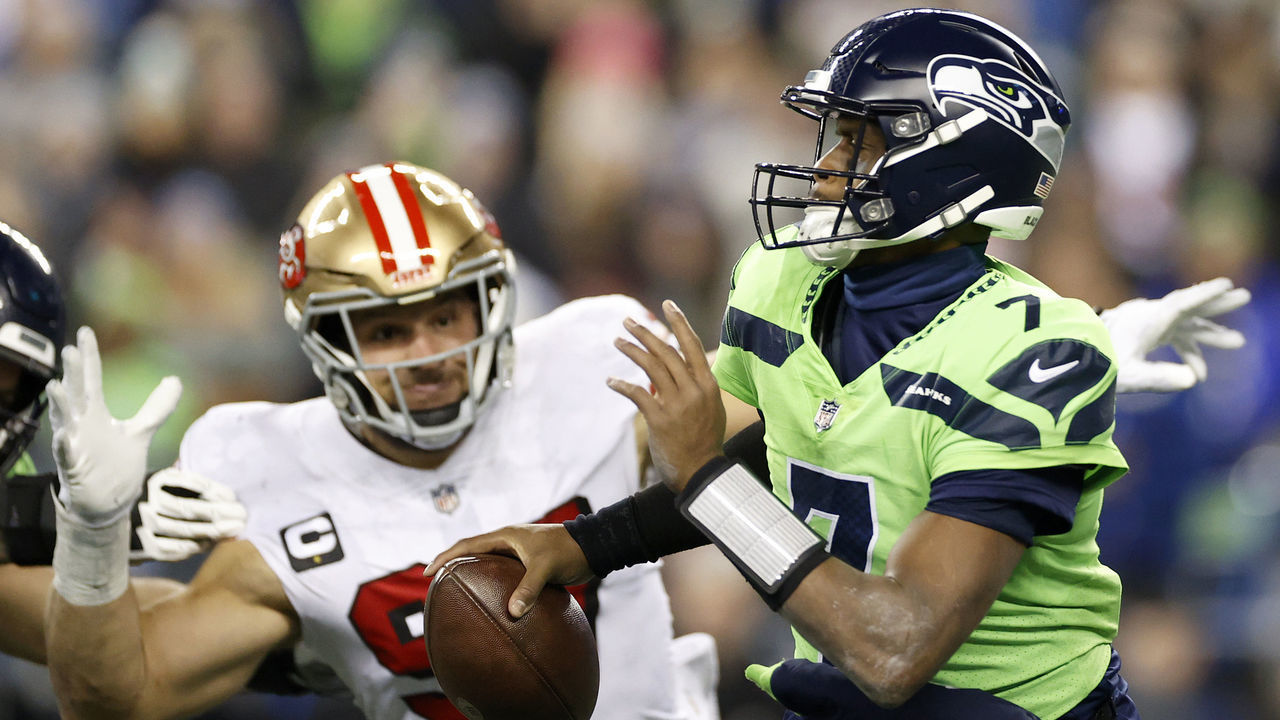 SEATTLE, WASHINGTON - DECEMBER 15: Nick Bosa #97 of the San Francisco 49ers pressures Geno Smith #7 of the Seattle Seahawks during the fourth quarter of the game at Lumen Field on December 15, 2022 in Seattle, Washington.
