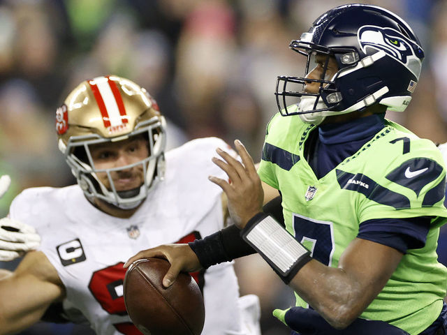 SEATTLE, WASHINGTON - DECEMBER 15: Nick Bosa #97 of the San Francisco 49ers pressures Geno Smith #7 of the Seattle Seahawks during the fourth quarter of the game at Lumen Field on December 15, 2022 in Seattle, Washington.