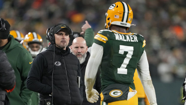 GREEN BAY, WISCONSIN - JANUARY 08: Head coach Matt LaFleur of the Green Bay Packers talks with Quay Walker #7 after he was disqualified for an unsportsmanlike penalty during the fourth quarter against the Detroit Lions at Lambeau Field on January 08, 2023 in Green Bay, Wisconsin.