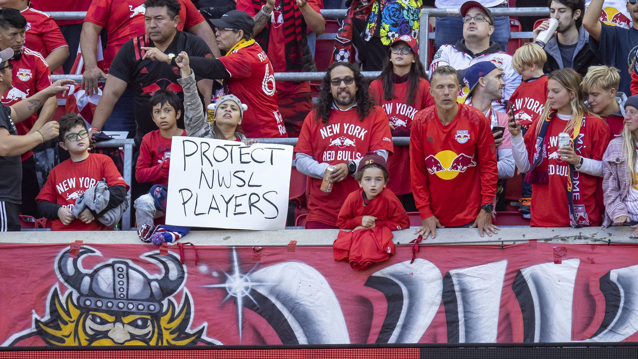 HARRISON, NJ - OCTOBER 09: A fan holds a sign that says Protect NWSL Players in reaction to report commissioned by the U.S. Soccer Federation and conducted by the former U.S. deputy general Sally Yates which outlined sexual misconduct and abuse in the National Womens Soccer League in the first half of the Decision Day Major League Soccer match against the Charlotte FC at Red Bull Arena on October 9, 2022 in Harrison, New Jersey.