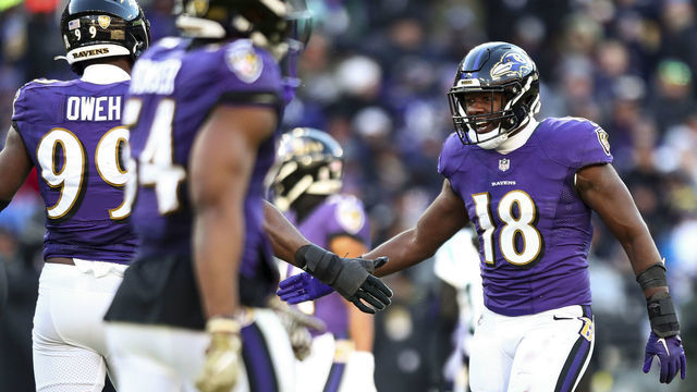BALTIMORE, MD - NOVEMBER 20: Roquan Smith #18 of the Baltimore Ravens high fives teammates after a play during the third quarter of an NFL football game against the Carolina Panthers at M&T Bank Stadium on November 20, 2022 in Baltimore, Maryland.