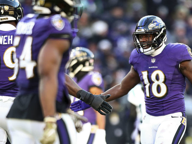 BALTIMORE, MD - NOVEMBER 20: Roquan Smith #18 of the Baltimore Ravens high fives teammates after a play during the third quarter of an NFL football game against the Carolina Panthers at M&T Bank Stadium on November 20, 2022 in Baltimore, Maryland.