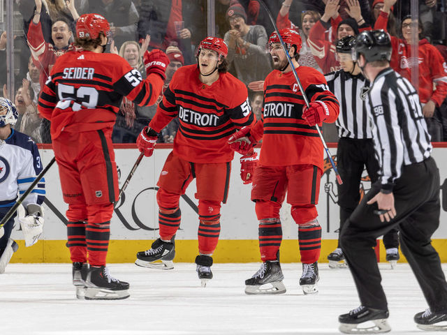 DETROIT, MI - JANUARY 10: Dylan Larkin #71 of the Detroit Red Wings scores a power play goal on Connor Hellebuyck #37 of the Winnipeg Jets on a pass from Moritz Seider #53 of the Wings during the second period of an NHL game at Little Caesars Arena on January 10, 2023 in Detroit, Michigan.
