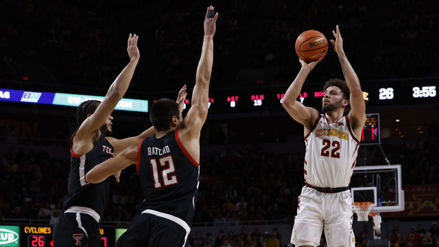 AMES, IA - JANUARY 10: Gabe Kalscheur #22 of the Iowa State Cyclones takes a three-point shot as Kevin Obanor #0 and Daniel Batcho #12 of the Texas Tech Red Raiders defend in the first half of play at Hilton Coliseum on January 10, 2023 in Ames, Iowa.