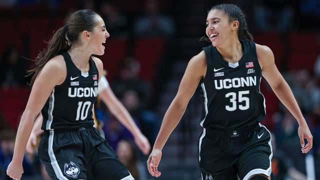 PORTLAND, OR - NOVEMBER 27: Nika Muhl #10 and Azzi Fudd #35 of the UConn Huskies celebrate during the game against the Iowa Hawkeyes at Moda Center on November 27, 2022 in Portland, Oregon.