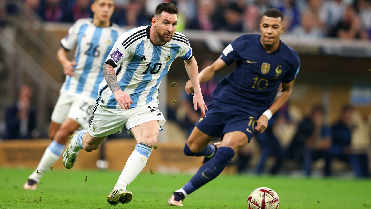 LUSAIL CITY, QATAR - DECEMBER 18: Kylian Mbappe of France vies with Lionel Messi of Argentina during the FIFA World Cup Qatar 2022 Final match between Argentina and France at Lusail Stadium on December 18, 2022 in Lusail City, Qatar.