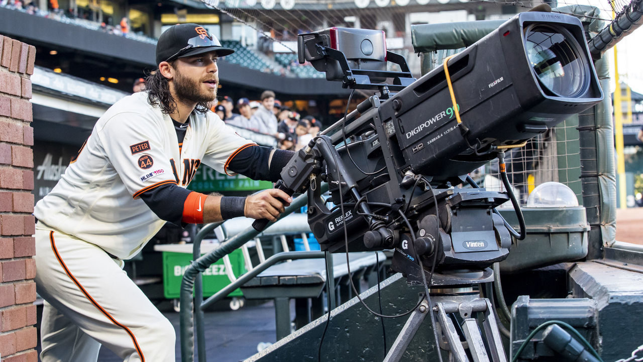SAN FRANCISCO, CA - AUGUST 29: San Francisco Giants Shortstop Brandon Crawford (35) tries his hand at the TV camera before the Major League Baseball game between the San Diego Padres and San Francisco Giants on August 29, 2019 at Oracle Park in San Francisco, CA.