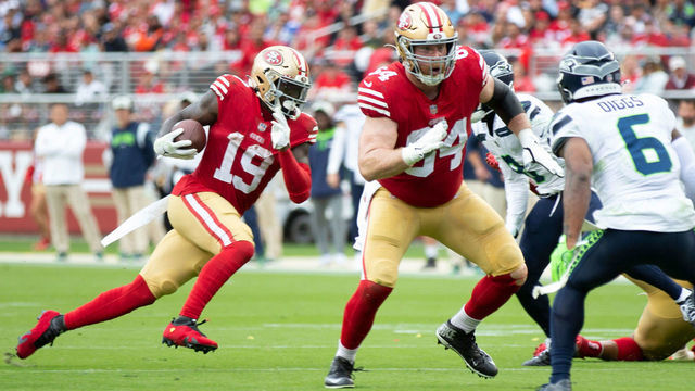 SANTA CLARA, CA - SEPTEMBER 18: Jake Brendel #64 of the San Francisco 49ers blocks as Deebo Samuel #19 runs after making a catch during the game against the Seattle Seahawks at Levi's Stadium on September 18, 2022 in Santa Clara, California. The 49ers defeated the Seahawks 27-7.