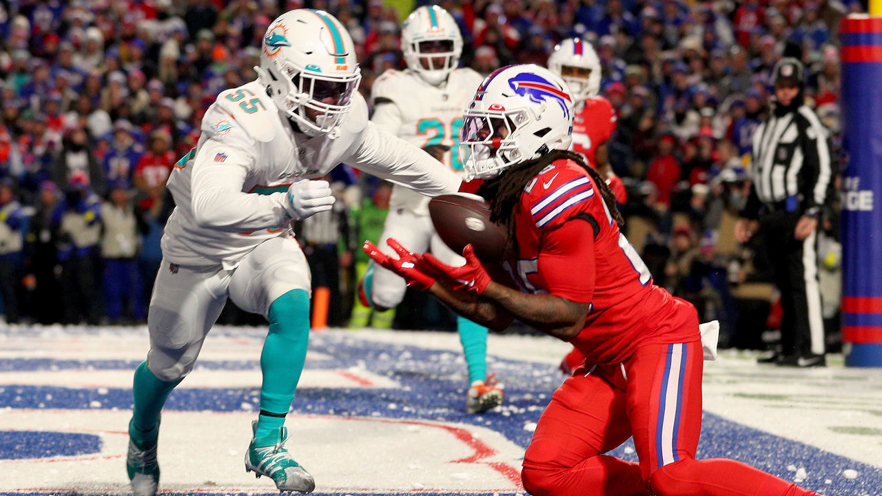 ORCHARD PARK, NEW YORK - DECEMBER 17: Jerome Baker #55 of the Miami Dolphins attempts to tackle James Cook #28 of the Buffalo Bills as he scores a touchdown during the third quarter at Highmark Stadium on December 17, 2022 in Orchard Park, New York.