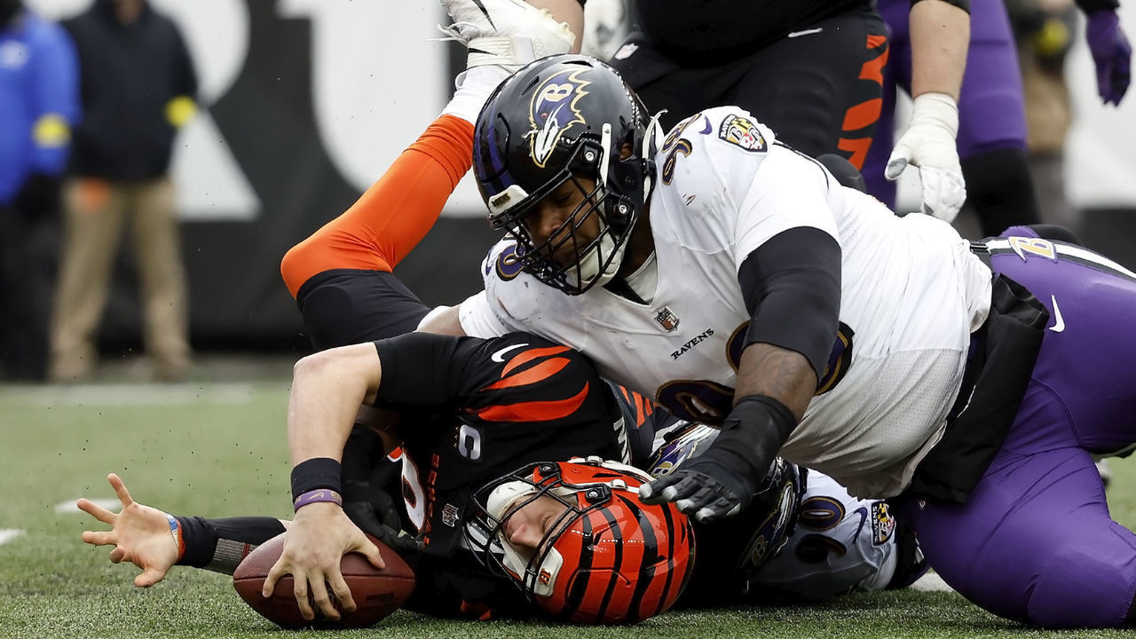 CINCINNATI, OH - JANUARY 08: Joe Burrow #9 of the Cincinnati Bengals is tackled by Travis Jones #98 of the Baltimore Ravens during the game at Paycor Stadium on January 8, 2023 in Cincinnati, Ohio.